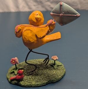 Russ tweet along with me yellow bird figure flying a kite